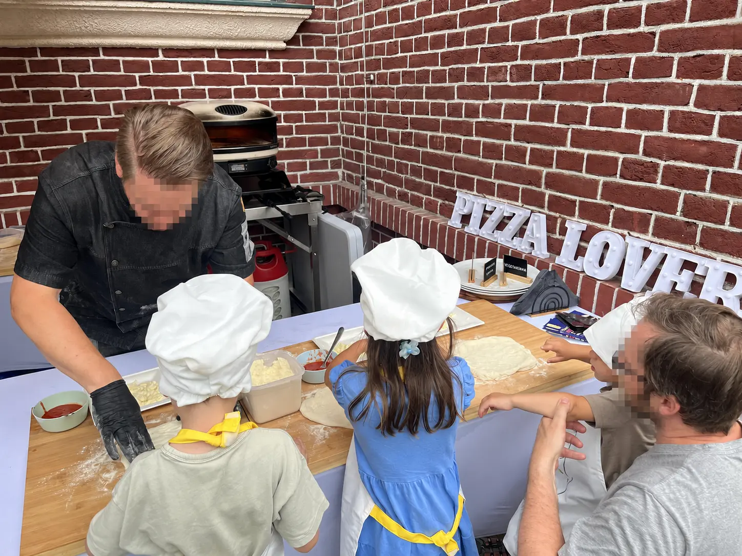 Family pizza workshop; all visible faces have been anonymised